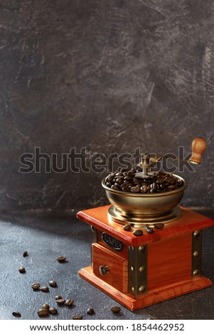 Similar – Foto Bild Kaffeemühle für den Handbetrieb aus solidem, naturfarbenem Holz mit schwarzer Einfüllkappe aus Metall steht am Rand eines runden weissen Tisches vor einer grauen Wand im fahlen Morgenlicht