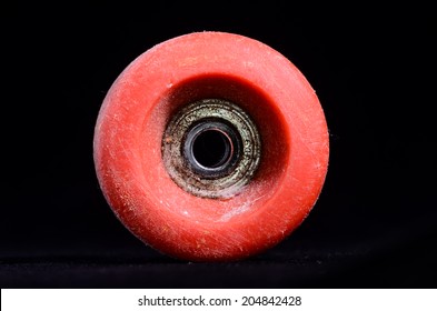 Old Vintage Consumed Skate Wheel On A Black Background