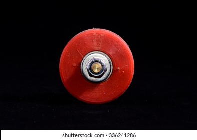 Old Vintage Consumed Skate Wheel On A Black Background