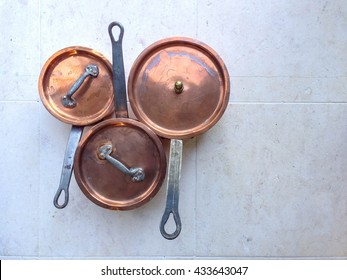 Old vintage copper pots in kitchen.  Top view, copy space for your text