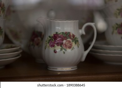 Old Vintage Crockery Creamer On The Counter Of An Antique Shop Or Flea Market.