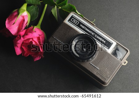old vintage instamatic camera with pink roses