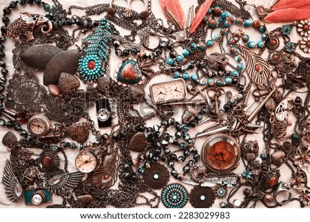 Old vintage jewelry fashion collection background. Pile of bronze, blue and red necklaces, earrings, bracelets, beads. Women beautiful bijouterie