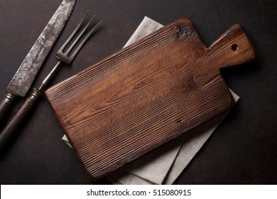 Old vintage kitchen utensils. Fork, knife, cutting board. Top view