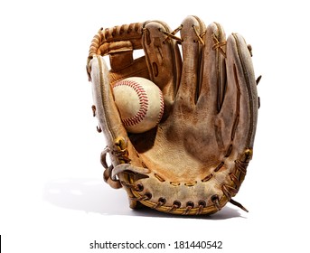 Old vintage leather baseball glove with the baseball held in the palm by the thumb standing upright on a white background