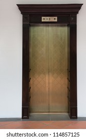 Old vintage lift with three levels on white wall