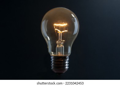 Old vintage light bulb close up on black background - Powered by Shutterstock