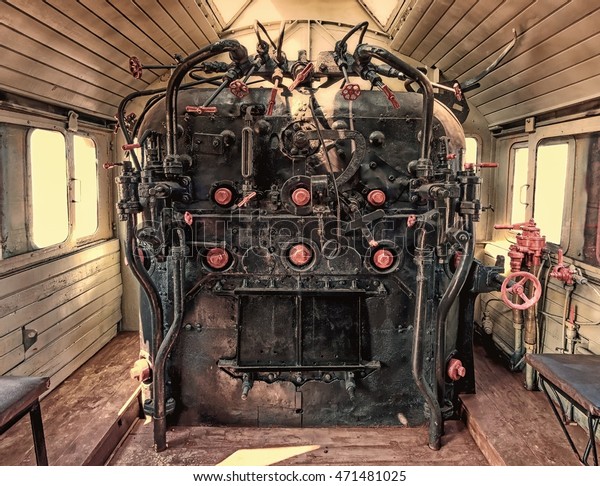 Old vintage locomotive cabin wide\
interior detail  faded photograph burned colors view \
