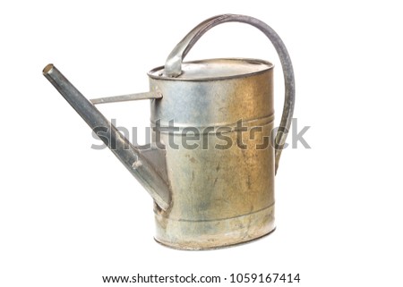 Old vintage metal watering can isolated on white background.