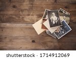 old vintage monochrome photographs, pictures taken in 1968, in sepia color are scattered on a wooden table, concept of genealogy, the memory of ancestors, family ties, memories of childhood