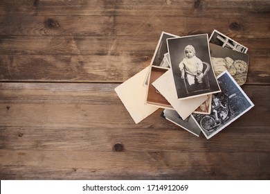 old vintage monochrome photographs, pictures taken in 1968, in sepia color are scattered on a wooden table, concept of genealogy, the memory of ancestors, family ties, memories of childhood - Shutterstock ID 1714912069