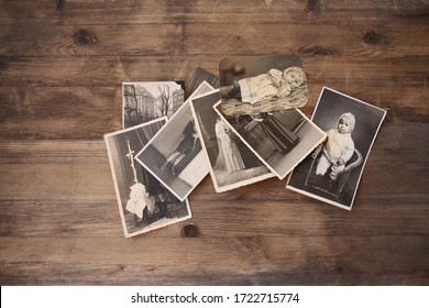 old vintage monochrome photographs are scattered on a wooden table, photographs of his and his sisters, pictures taken in 1964, concept of genealogy, the memory of ancestors, family ties, memories  - Shutterstock ID 1722715774