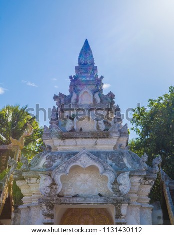 Old vintage Naga Bun Arch of Wat Phra That Lampang Luang with Light anf Shadow on Blue Sky Cloud Background in Niceday.