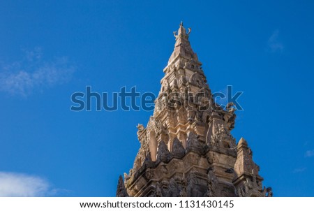 Old vintage Naga Bun Arch of Wat Phra That Lampang Luang with Light anf Shadow on Blue Sky Cloud Background in Niceday.