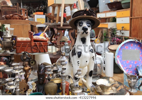 Old vintage objects and\
furniture for sale at a flea market. Toy vintage dog. Selective\
focus