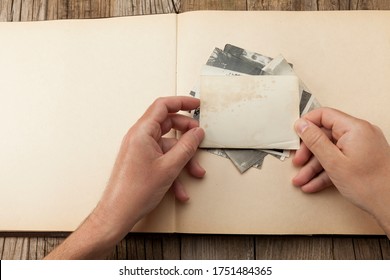 Old Vintage Photo Template (mockup) In Hands On Wooden Background. Empty Retro Card, Textured Paper.