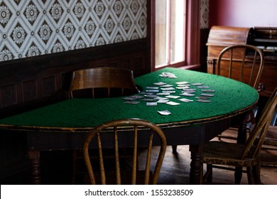 Old Vintage Poker Cards Room. Green Table With Cards And Bottles 