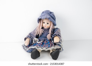 Old vintage rag doll in a dress.