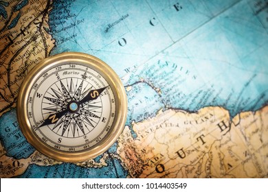 Old vintage retro compass on ancient map background. Travel geography navigation concept background. - Shutterstock ID 1014403549