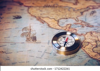 Old vintage retro golden compass on ancient map. Selective focus, shallow depth of field. Concept of world travel, sightseeing and tourism.