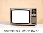 Old vintage and retro style television with cut out screen. Old television on table in front of wall background. Classic old obsolete TV with white screen.