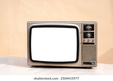 Old vintage and retro style television with cut out screen. Old television on table in front of wall background. Classic old obsolete TV with white screen.