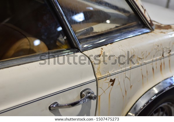 Old vintage\
rusty car rear part, wheel\
closeup