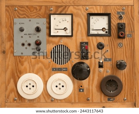old vintage self made technical instrument with switches, sockets and measuring scales in a wooden box