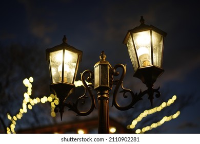 Old Vintage Street Lamp On The Road At Night. Old Vintage Streetlight On Dark Night.