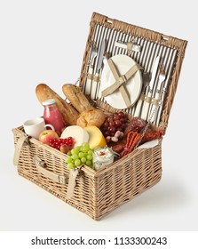 Old Vintage Style Picnic Hamper Packed With Food For A Healthy Summer Lunch Outdoors With Fresh Fruit And Juice, Cheeses, Spicy Sausages, Spread And Baguettes Isolated On White