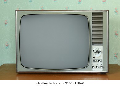 Old vintage TV in a room with vintage wallpaper. Interior in the style of the 1960s. - Shutterstock ID 2153511869