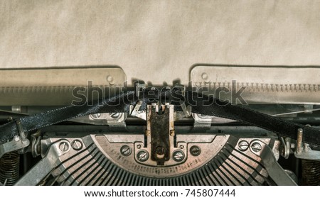 Old vintage typewriter with blank paper. close-up