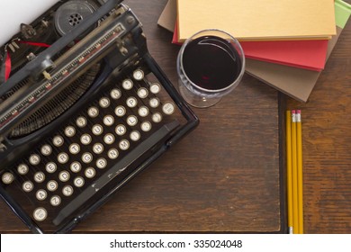 Old Vintage Typewriter With Glass Of Wine Pencils And Books In This Retro Creative Writing And Relazation Themed Desk Top