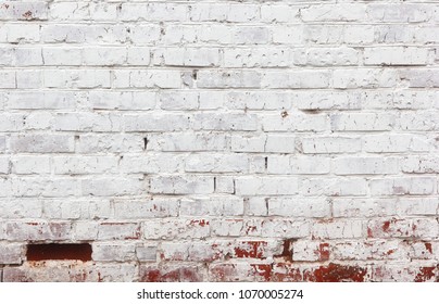 Old vintage whitewashed red brick wall. Brickwork with flakes of exfoliated white paint. Texture of a shabby stone wall with no empty block. - Shutterstock ID 1070005274