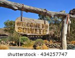 old vintage wood signboard with text " welcome to Soweto" hanging on a branch