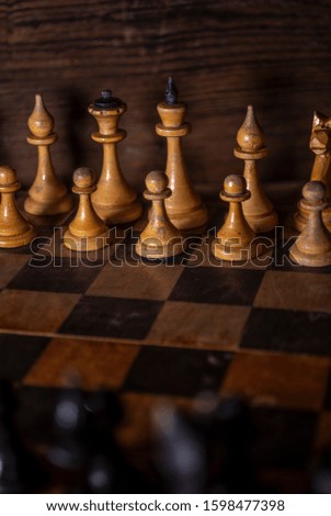 Old vintage wooden chess and a shabby chessboard