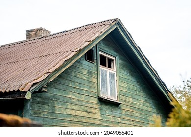 Old Vintage Wooden House With Tiled Slanted Roof And Chimney