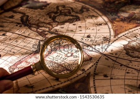 old vintage world map magnifying glass and scroll, travel and tourism concept