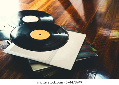 Old Vinyl Record And A Collection Of Albums On Wooden Background