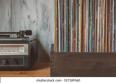 Old Vinyl Records In A Box And The Player Standing On The Table