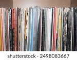 Old vinyl records collection in close up view texture background. Collection of vinyl records stacked together in a shelf. 