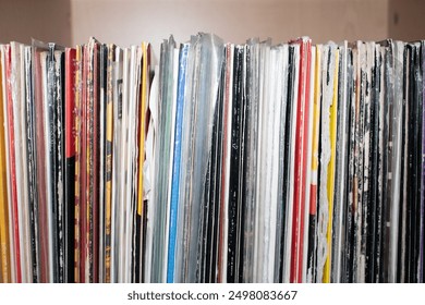 Old vinyl records collection in close up view texture background. Collection of vinyl records stacked together in a shelf.  - Powered by Shutterstock