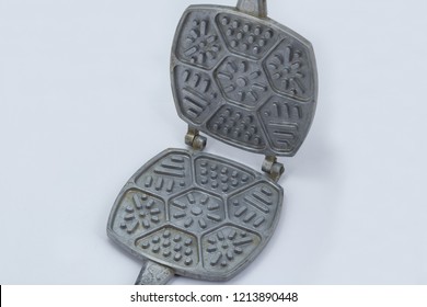 Old Waffle Iron For Baking Of Cookies Close Up In On A White Background