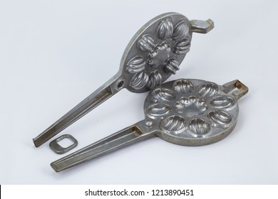 Old Waffle Iron For Baking Of Cookies In The Form Of Nutlets In The Opened Type Of A White Background