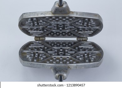 Old Waffle Iron For Baking Of Cookies Close Up Of On A White Background