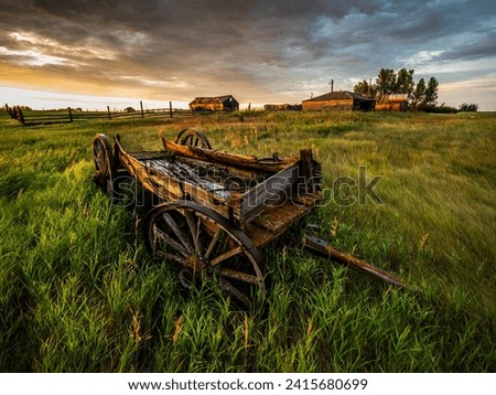 Old wagon on an abandoned farm in central Saskatchewan. The wagon comes from the horse drawn era. Abandoned farms like this dot the prairies.