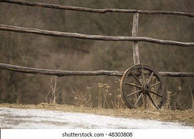 old wagon wheel near the fence