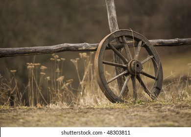 old wagon wheel near the fence