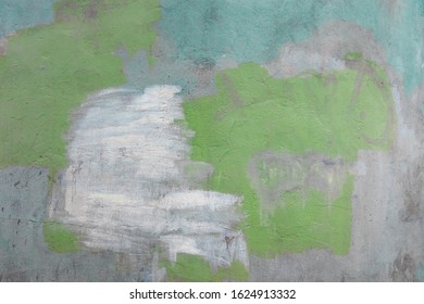 Old Wall Background With Green, Blue And White Stains And Old Graffitti Remains.