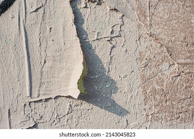 An old wall damaged- city building. Architecture- abstract background. Remnants of paint and plaster